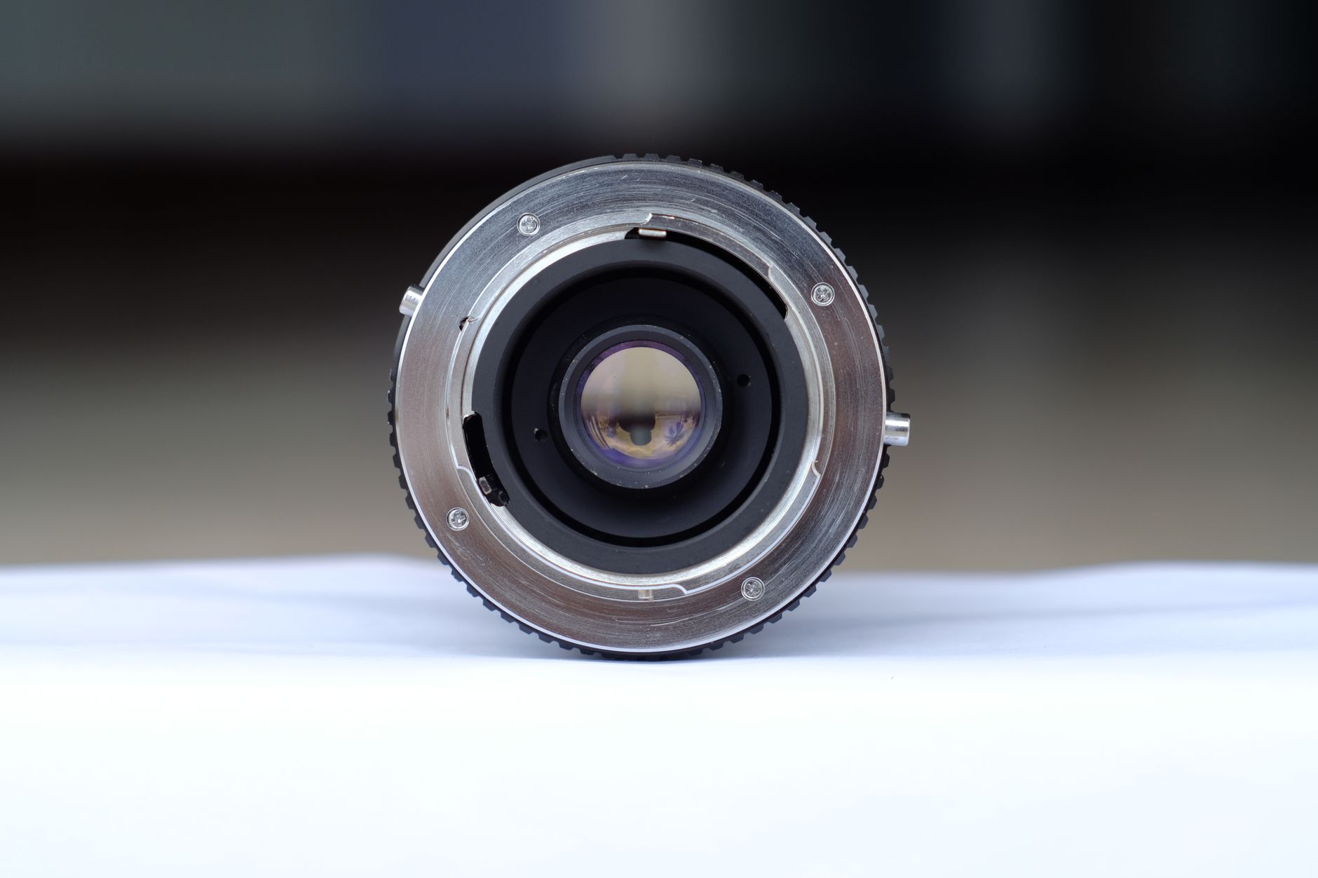 a massive metallic camera lens in a clean room