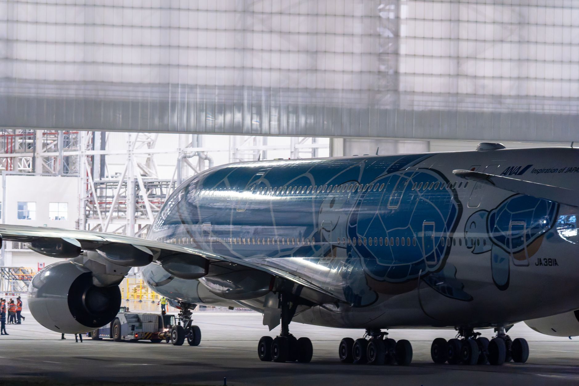 a massive jet engine blowing air onto a tiny soccer ball