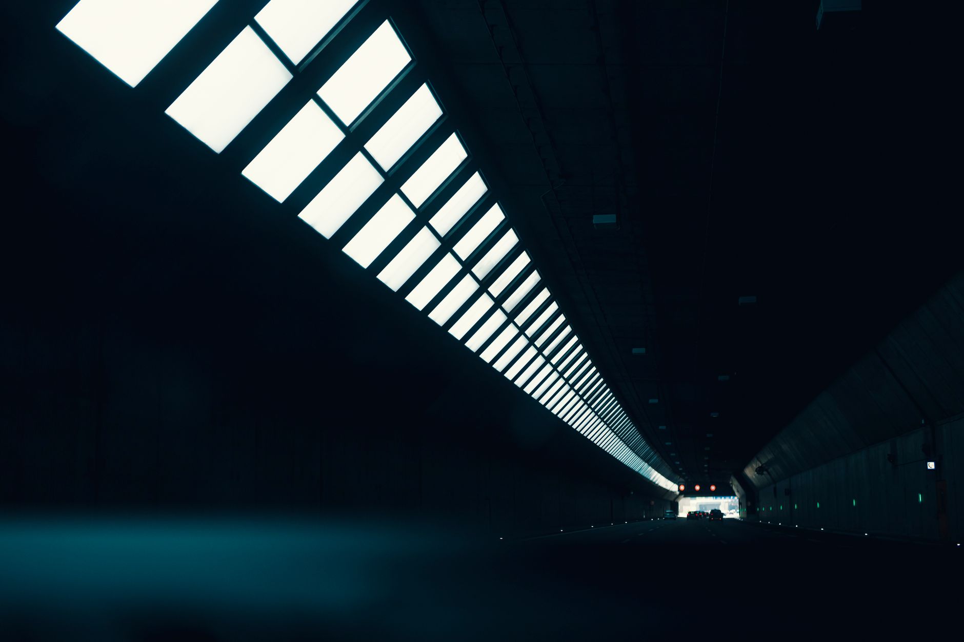 a massive rusted steel turbine blade inside a dark tunnel