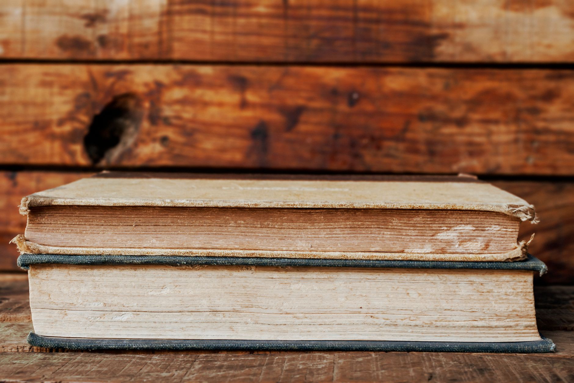 a stack of vintage books tied with a silk ribbon