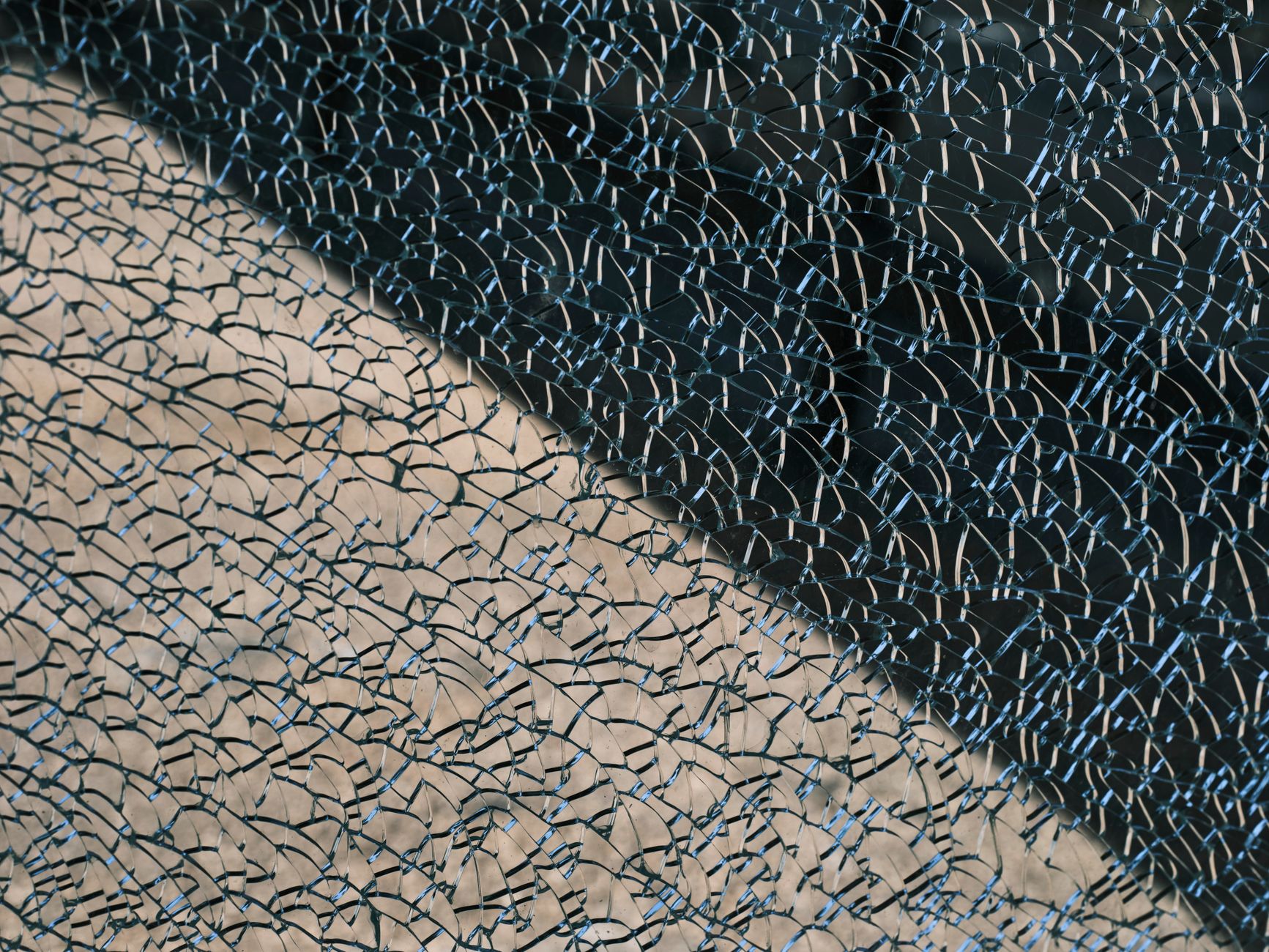 a single cracked glass marble on a pedestal