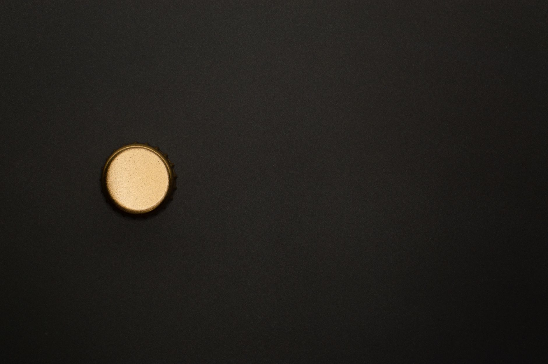 a single gold-plated silicon wafer on a velvet cushion